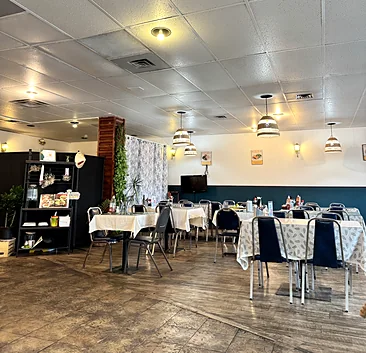 Vietnamese Diner dining room with tables set with cloths