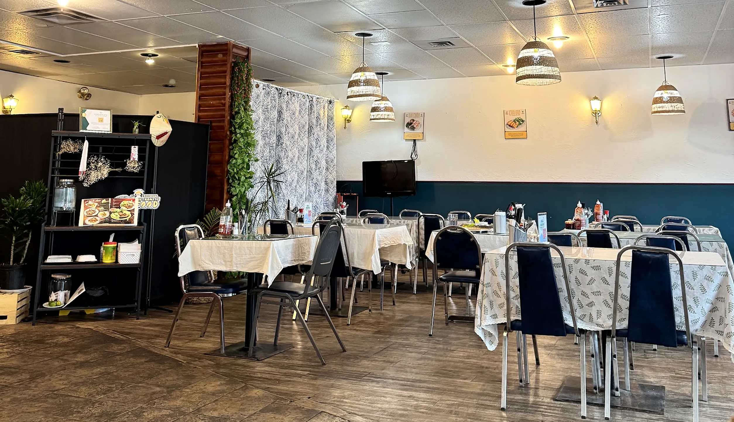 Vietnamese Diner dining room with tables set with cloths