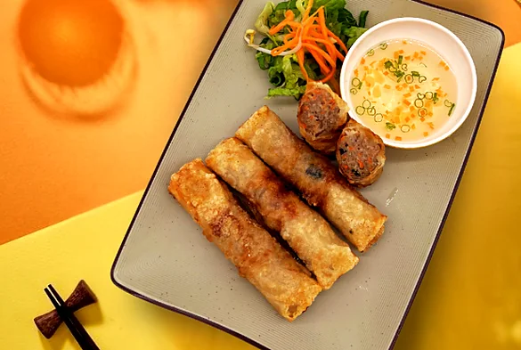 Crispy fried spring rolls with pickled carrot salad and dipping sauce