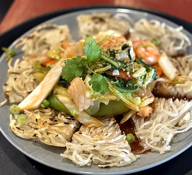Crispy pan-fried noodles topped with shrimp and stir-fried vegetables