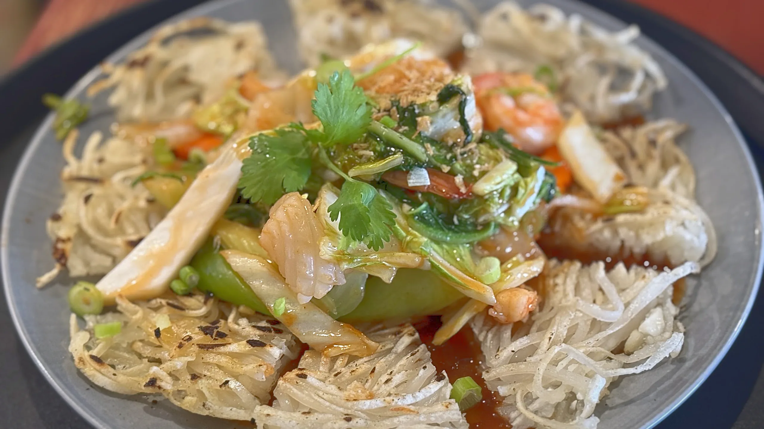 Crispy pan-fried noodles topped with shrimp and stir-fried vegetables